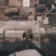 Person standing on glass floor overlooking city below